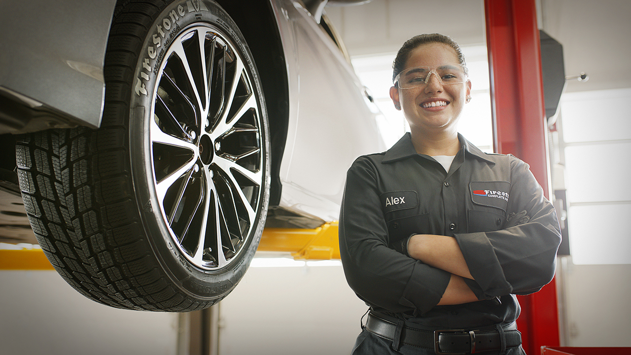 a woman in a uniform standing next to a car