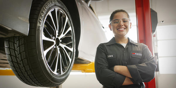 a woman in a uniform standing next to a car