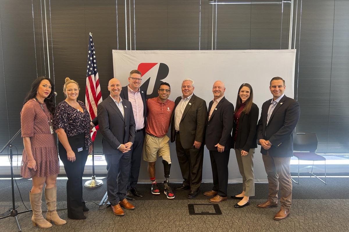a group of people standing in front of a white board