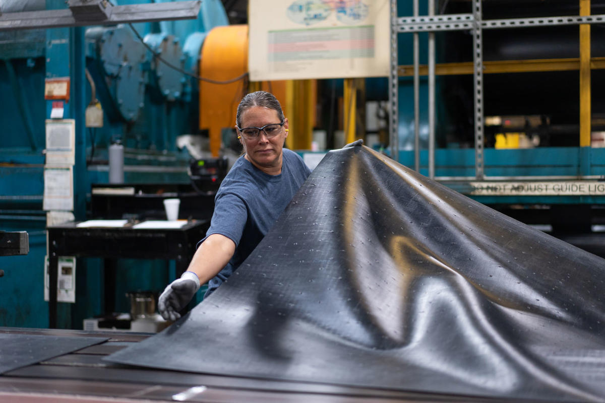 a woman holding a black sheet