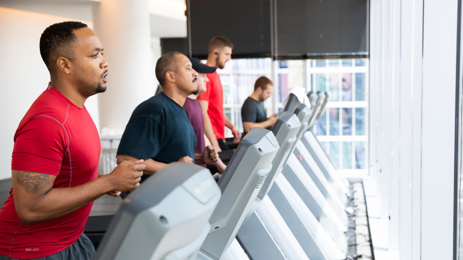 a group of men on treadmills