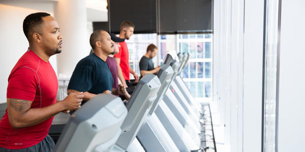 a group of men on treadmills
