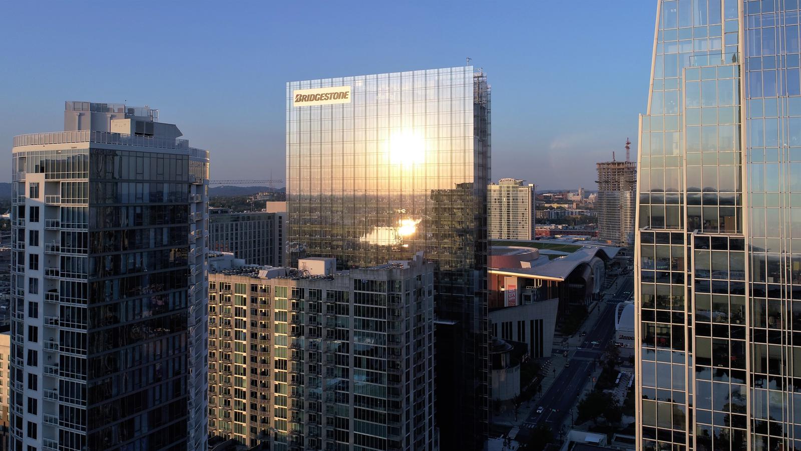 a sun reflecting on a glass building
