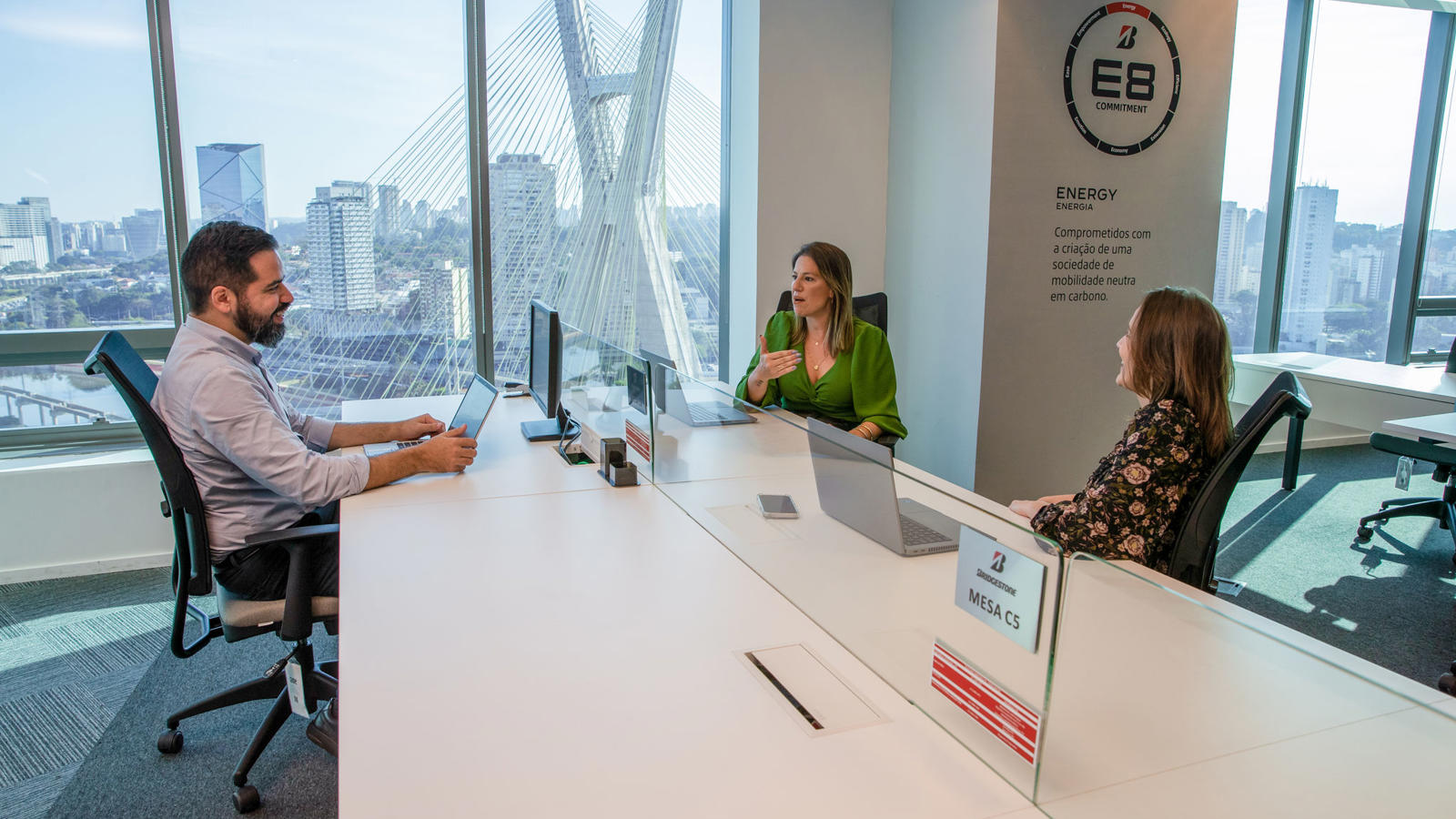 a group of people sitting at a table in an office