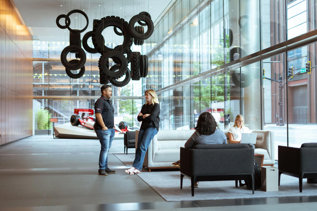 a group of people in a room with tires from ceiling