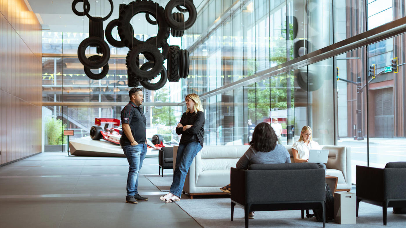 a group of people in a room with tires from ceiling