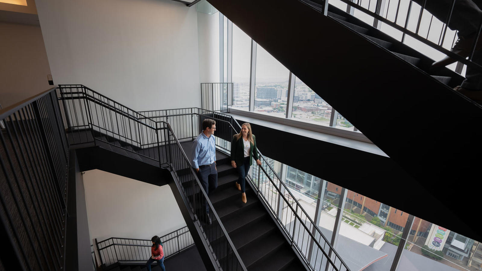 a man and woman walking up stairs