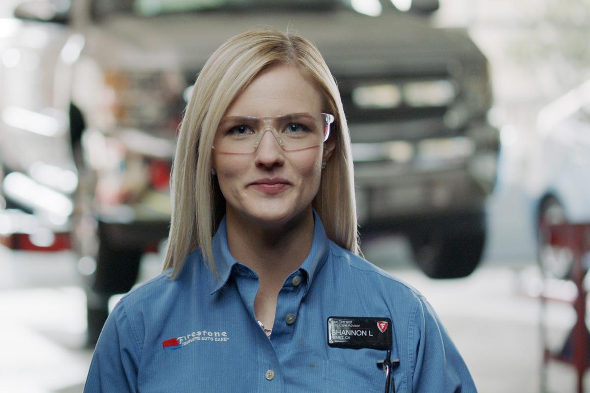 a woman wearing glasses and a blue shirt