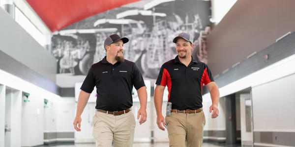 two men walking in a building