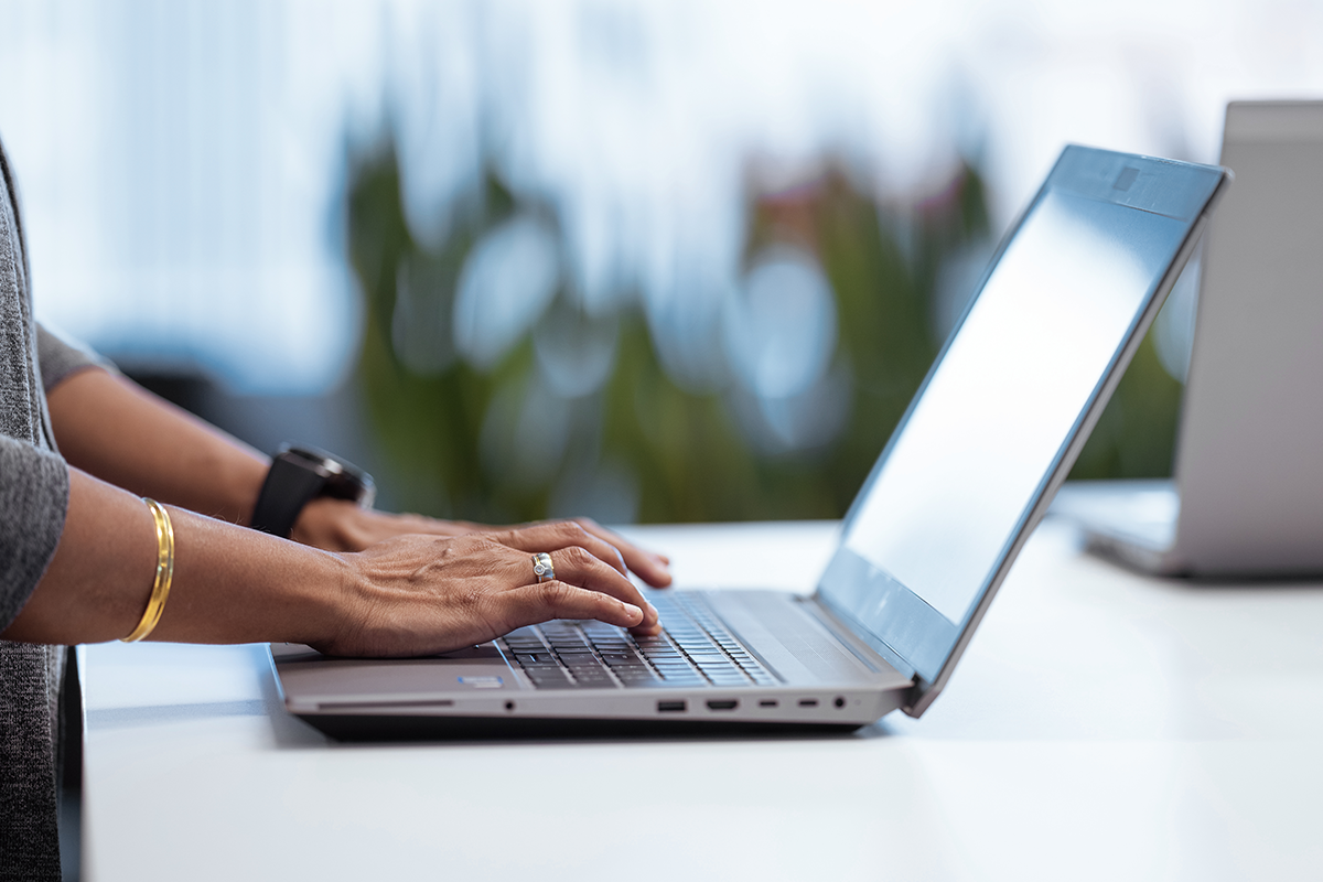 a person typing on a laptop