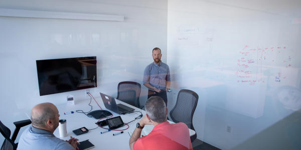a man standing in front of a whiteboard