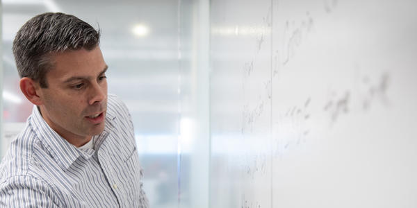 a man looking at a whiteboard
