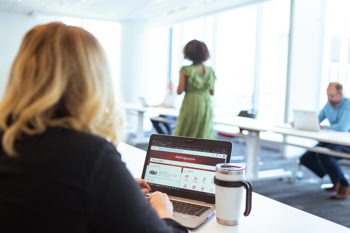 a woman sitting at a desk with a laptop