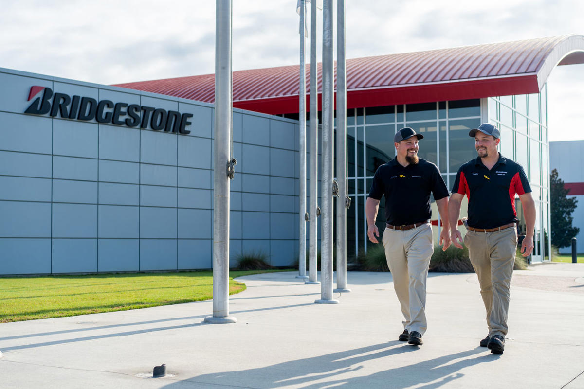 two men walking in front of a building