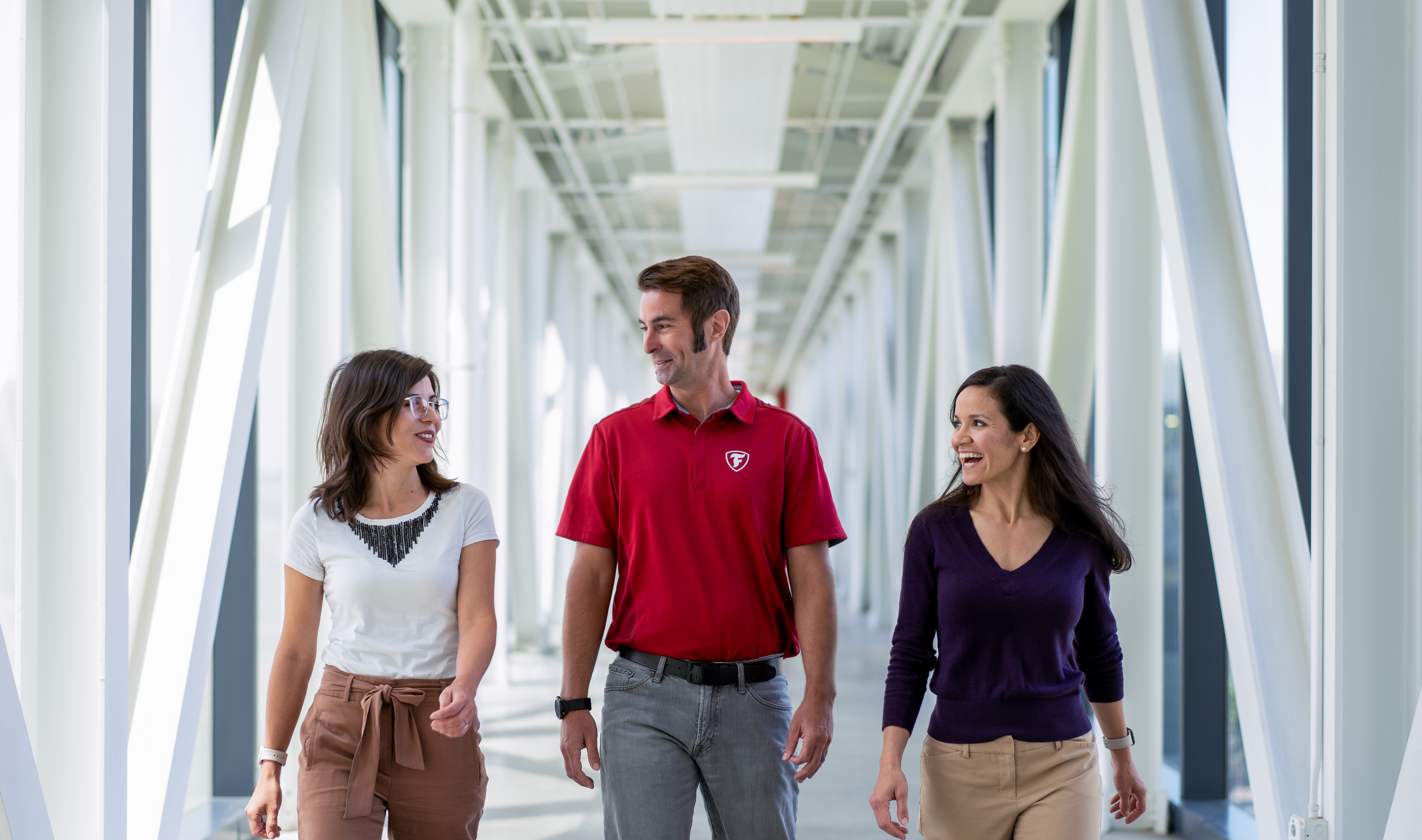 a group of people walking in a hallway