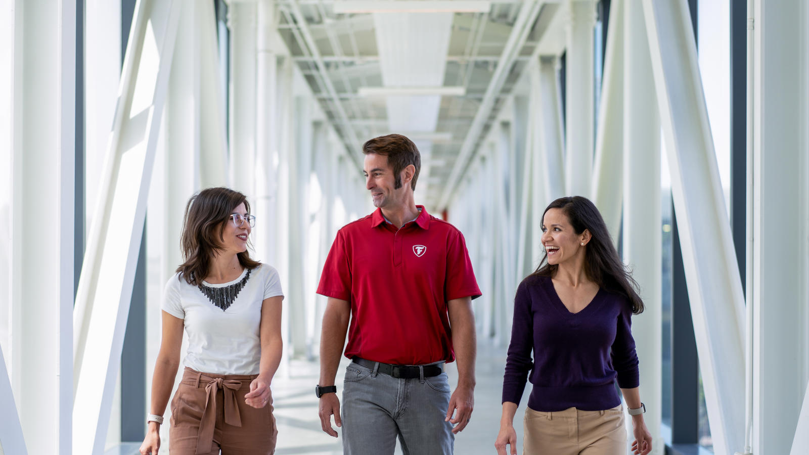 a group of people walking in a hallway