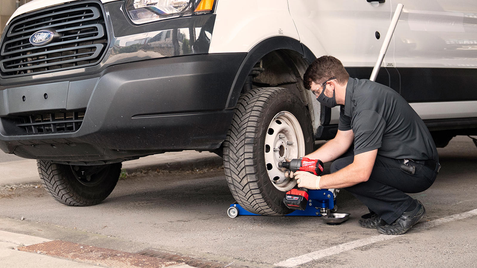 a man using a jack to change a tire