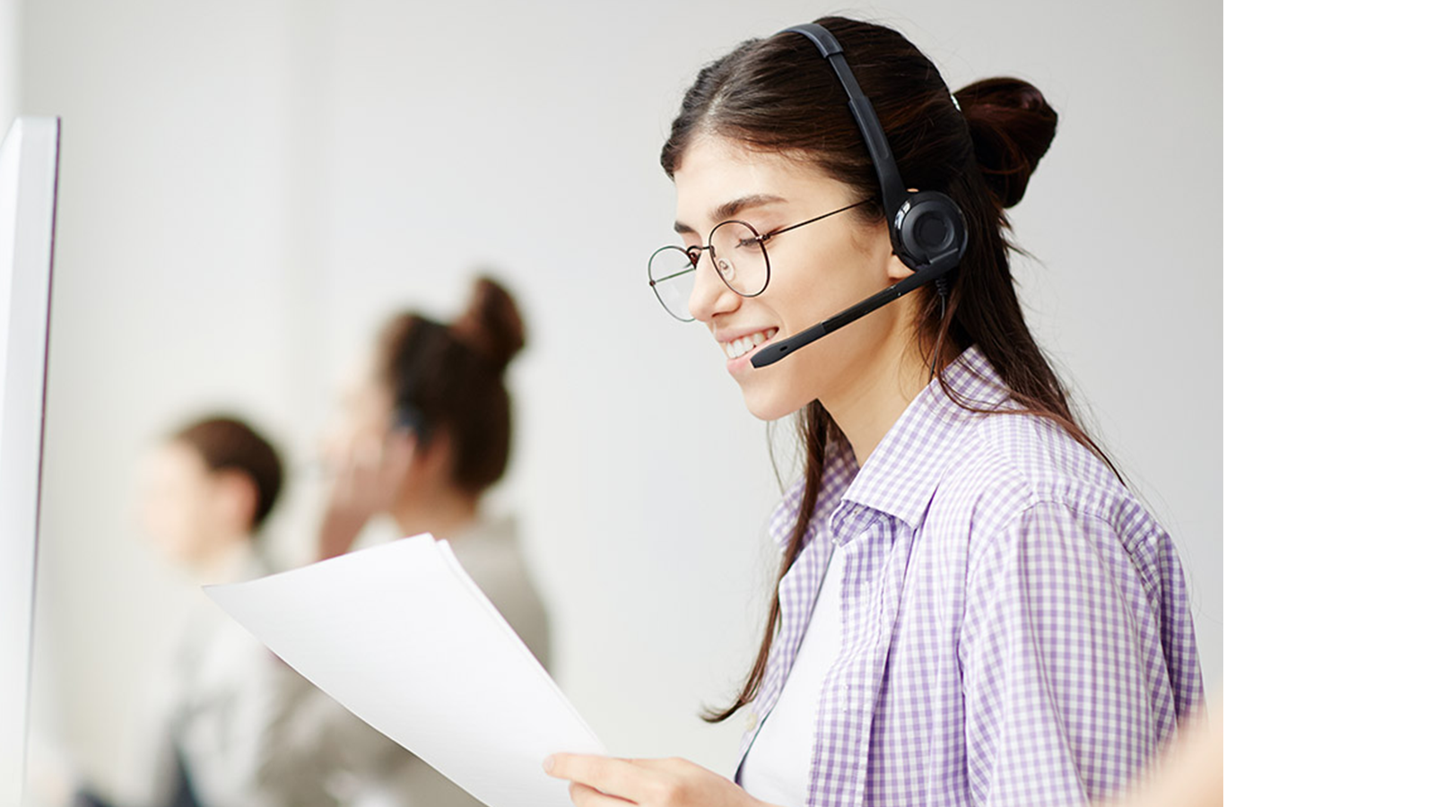 a woman wearing a headset and holding a paper