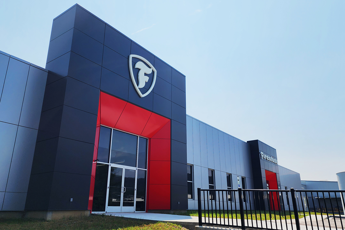 a building with a black gate and red trim